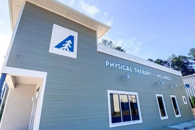 The side of the Ascend Physical Therapy and Wellness building with its Physical Therapy + Wellness sign